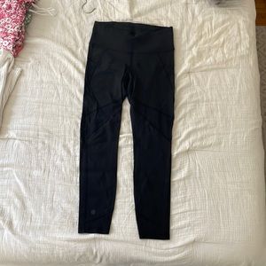 Black athleta leggings with mesh details goes down to right above ankles